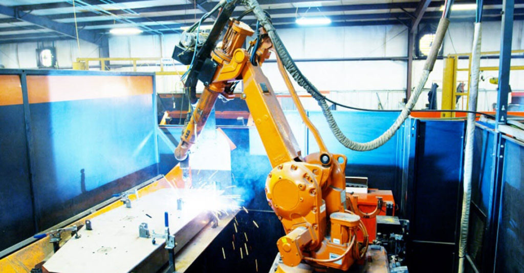 A robotic welding cell on a production line