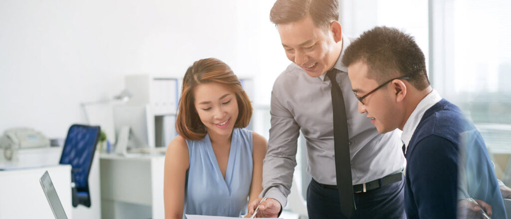 Three colleagues reviewing a document