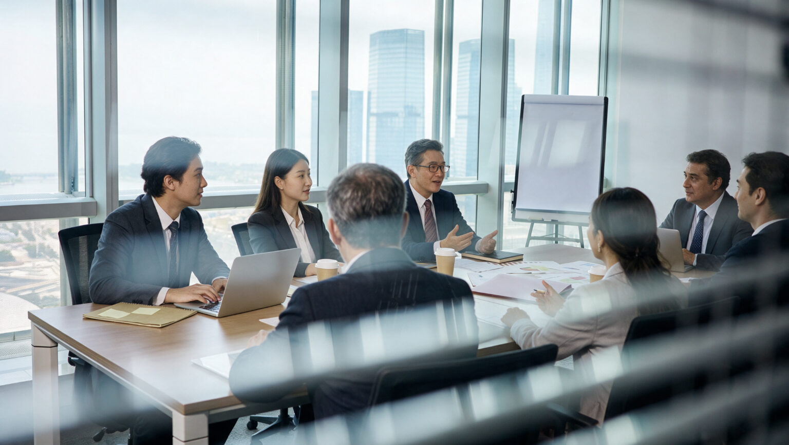 Senior managers in discussion in a glass-walled boardroom