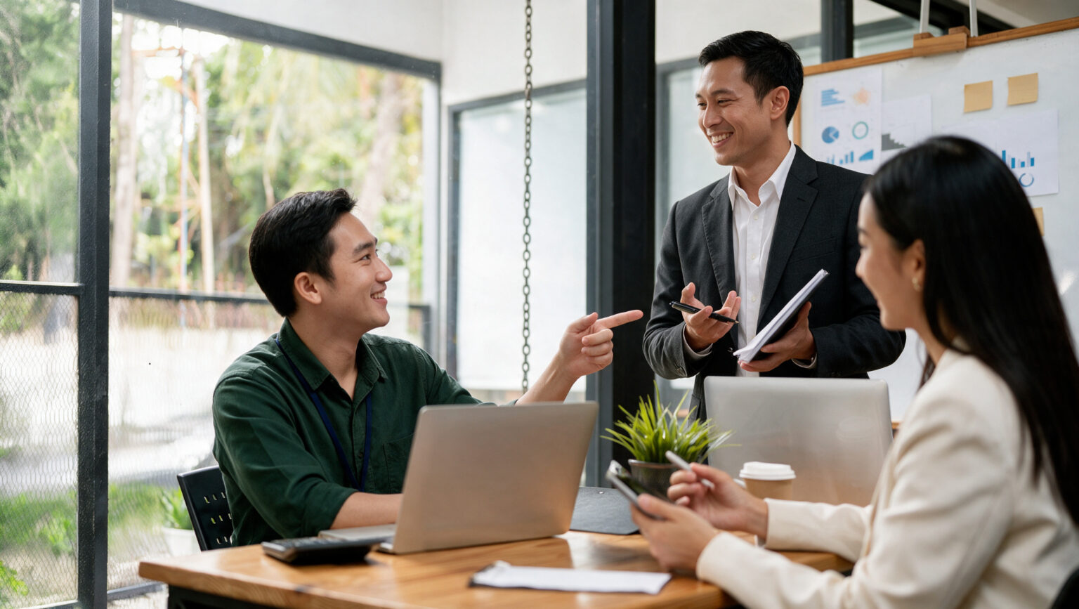 Three professionals studying together by a window